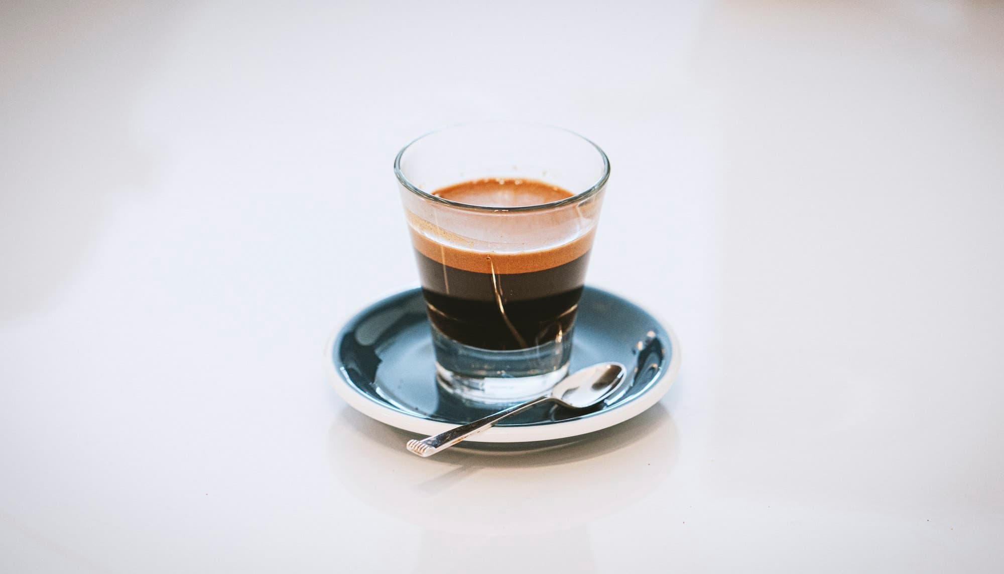 An espresso shot in a small ceramic cup