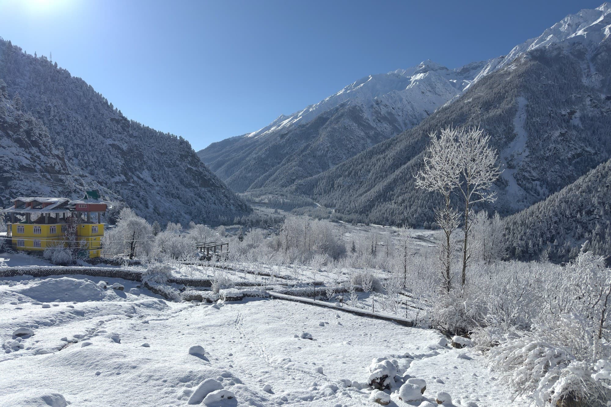 The Tribe Inn at dusk with the Kinner Kailash range rising behind Rakchham village