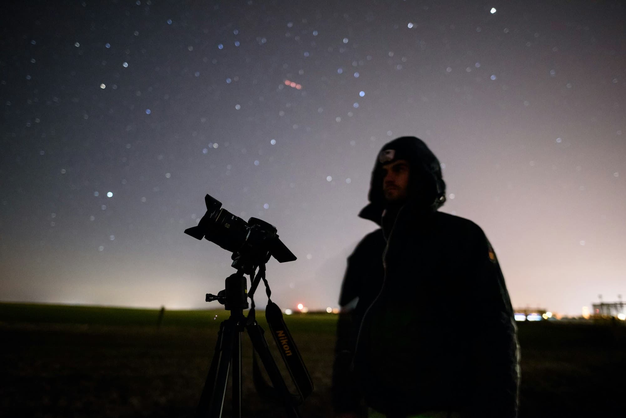 Telescope silhouette under stars